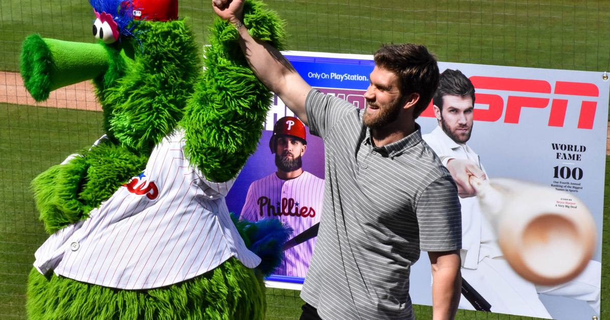 Bryce Harper raises hands with the Philly Phanatic at his initial press conference after signing with the Phillies